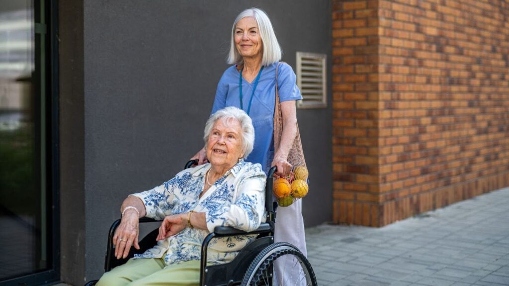Elderly woman smiling during a social support visit at home in Australia.